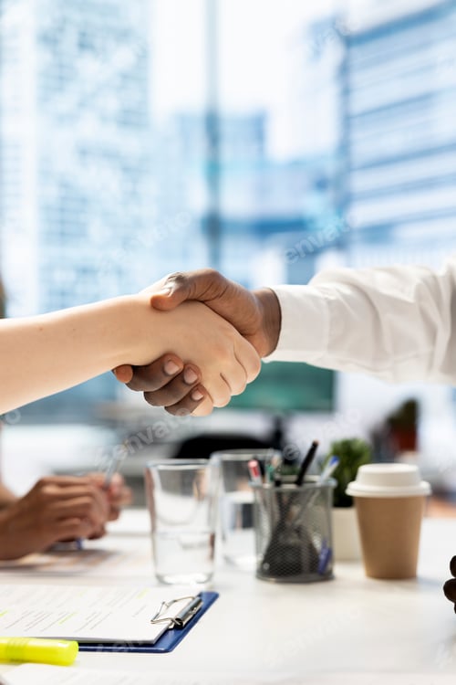 Preview: Businesspeople meeting, doing greeting handshake gesture in office workspace
