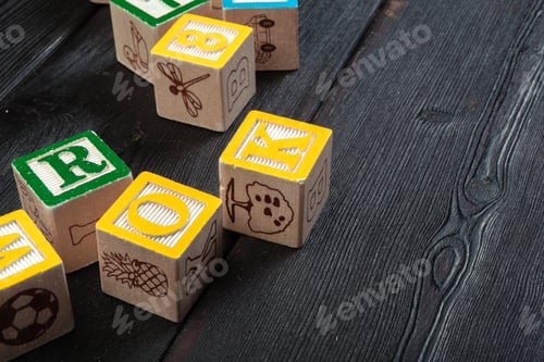 Preview: Letters background. Wooden cubes with letters on wooden background