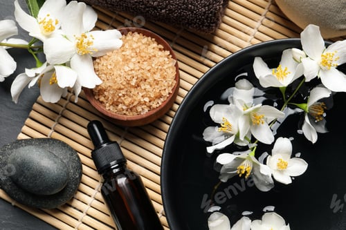 Preview: Beautiful spa composition with jasmine essential oil and fresh flowers on table, flat lay