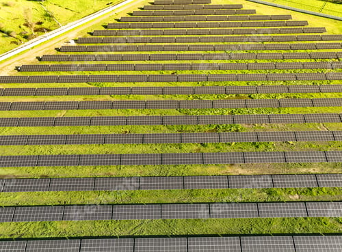 Preview: Solar panels on field in summer, aerial drone view