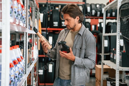 Preview: Looking for the right new oil. Man is in the tire fitting car service