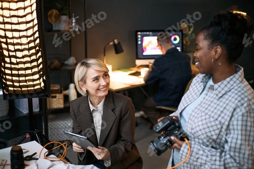 Preview: Caucasian Middle Aged Woman Collaborating with Black Young Adult Woman