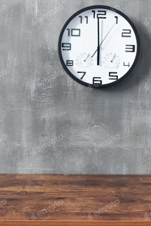 Preview: wall clock and table near concrete background
