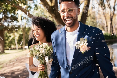 Preview: Shot of a happy newlywed young couple getting showered with confetti outdoors on their wedding day