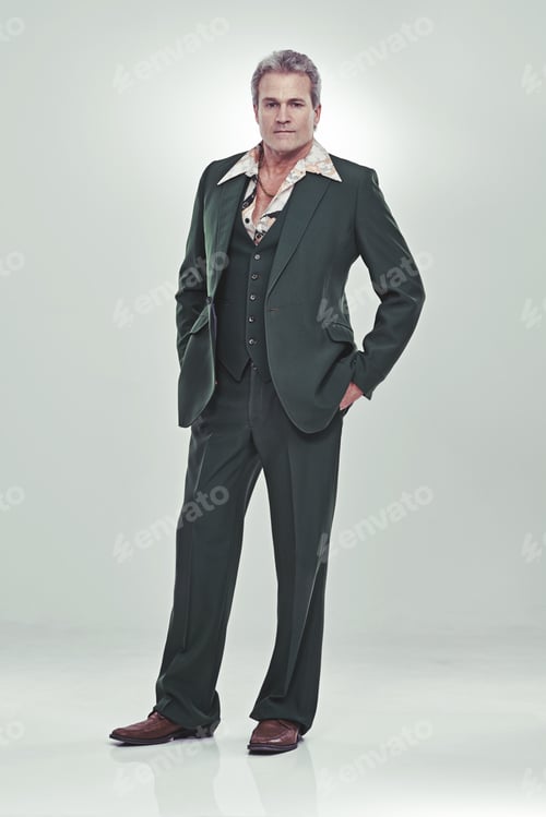Preview: Full length studio portrait of a mature man in a retro suit striking a confident pose