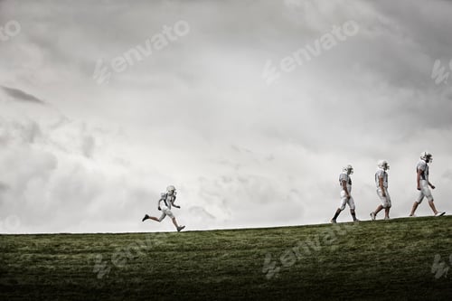 Preview: A group of three tall football players walking, with one smaller figure running after them.