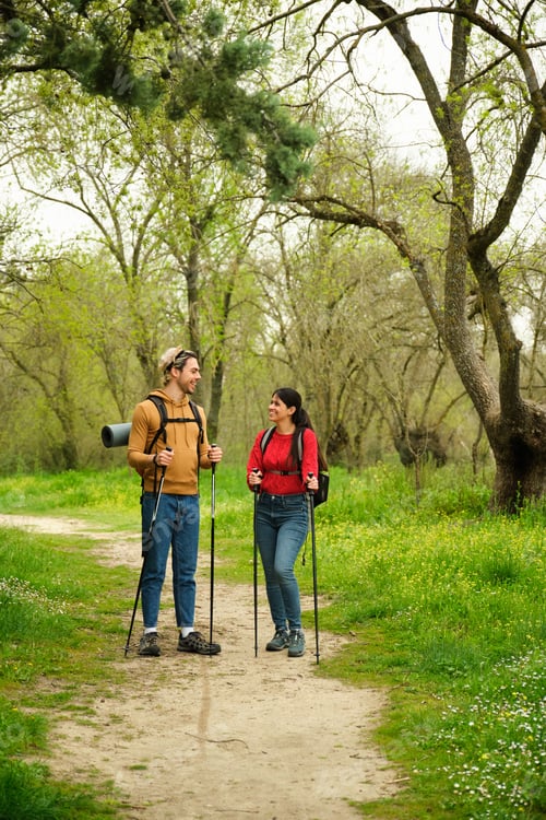 Preview: A man and a woman are walking in a forest, both carrying backpacks