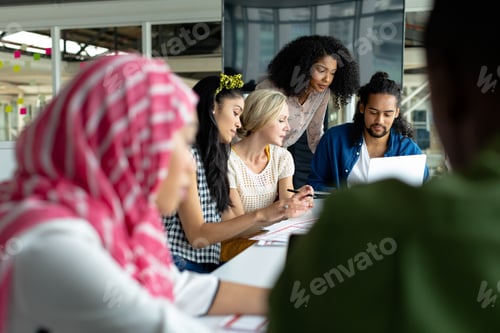 Preview: Diverse business people working together on laptop at conference room