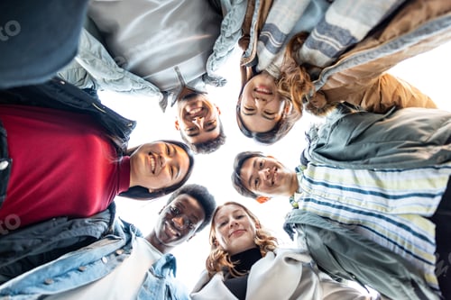Preview: Multiracial friends together in a circle looking at camera