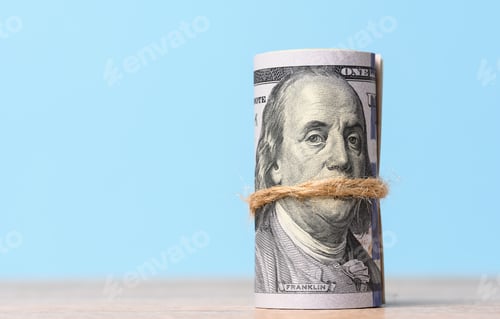 Preview: Rope tied roll of one hundred dollar bills on a blue background,