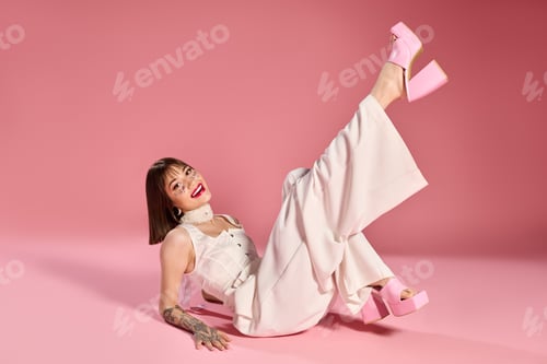 Preview: Young womans joyful pose in stylish attire against a vibrant pink backdrop