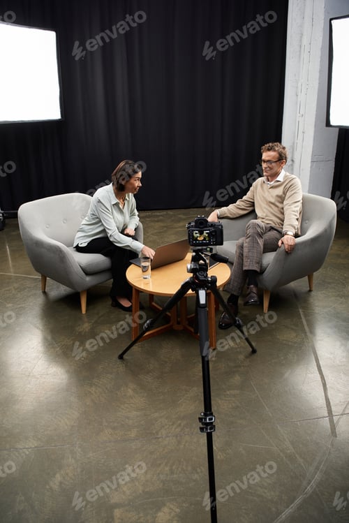 Preview: Professional journalist conducts in-depth interview with specialist in modern studio setting
