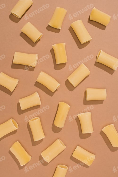 Preview: top view of pasta spilled on beige surface