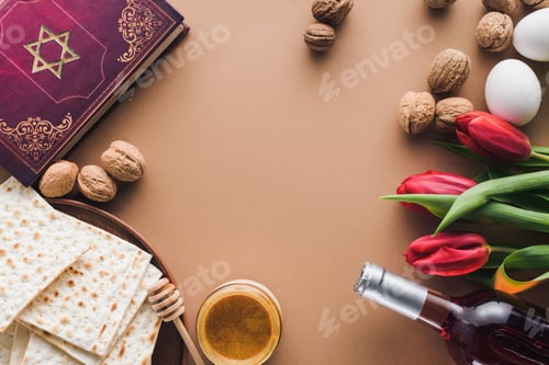 Preview: top view of traditional book with text in hebrew, wine and matza on tabletop