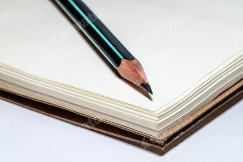Preview: Pencil and a blank notebook