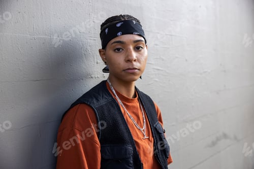 Preview: Young African American woman wearing black bandana and a vest outside
