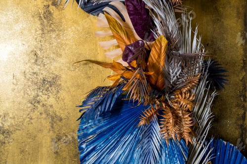 Preview: Creative layout with colorful tropical leaves on golden background. Minimal summer exotic concept