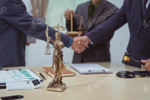 Preview: Three lawyers in a meeting at the table in an office, shaking hands discussing business, focusing
