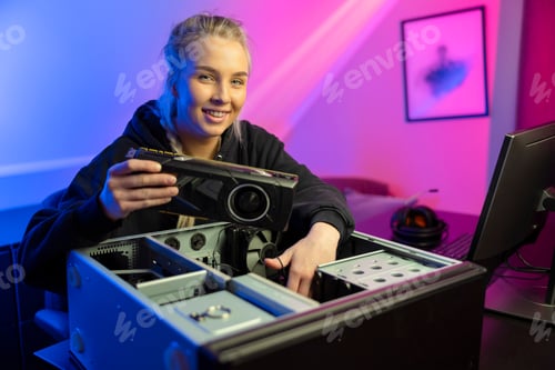 Preview: Smiling E-sport Gamer Girl Installing New GPU Video Card in Her Gaming PC