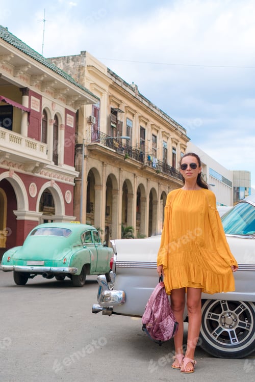 Preview: Happy woman in popular area in old Havana, Cuba. Young girltraveler smiling happy background