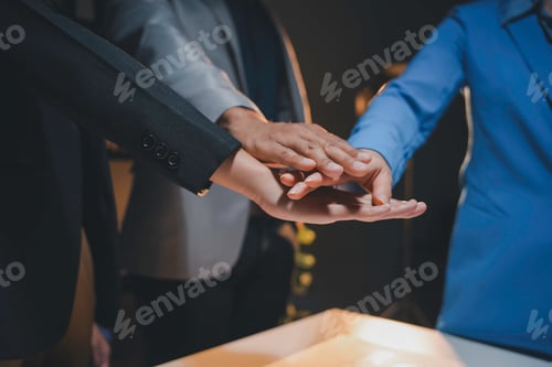 Preview: Business team is joining their hands together, showing their teamwork and cooperation