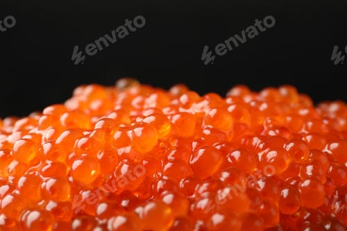 Preview: Delicious red caviar on black background, closeup