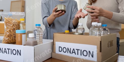 Preview: Volunteer preparing free foodstuff rations for poor people. Charity two woman of the community work