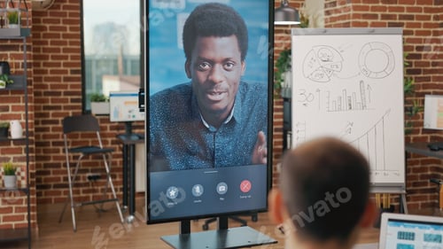 Preview: Colleagues meeting with man on video conference