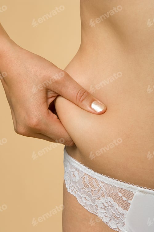 Vista previa: Woman grabbing her midriff flesh