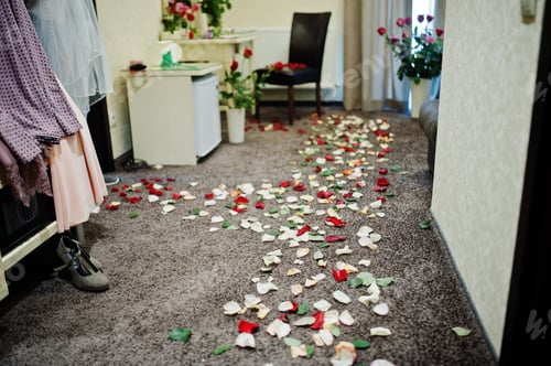 Preview: Beautiful wedding set decoration. Petals of roses on room of bride.