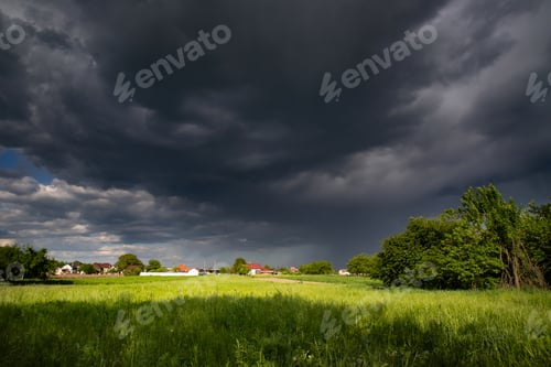 Preview: Panorama of rural landscape at wild changing stormy weather condition with rain and sun