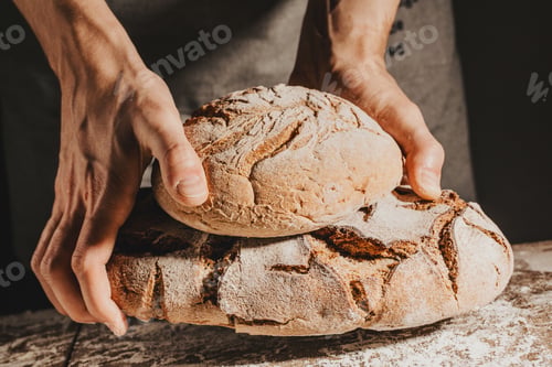 Preview: Baker or chef holding fresh made bread