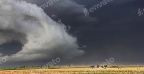 Preview: Dramatic storm clouds hovering over a calm field.