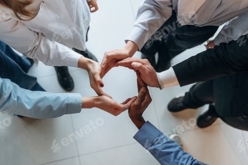 Preview: Making circle gesture by hands. Top view of hands of business people that are celebrating success