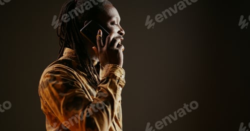 Preview: Cool guy with dreads answering phone call in studio