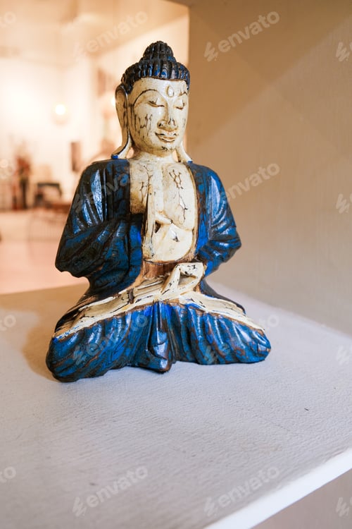 Preview: Antique Cracked Buddha Statue with Blue Accents on Display