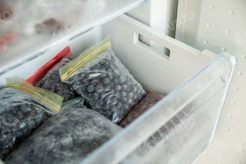 Preview: Blueberries frozen for winter in plastic zip bags. Freezer with healthy summer berries preservations