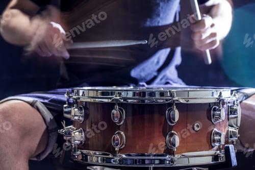 Preview: Man plays musical percussion instrument with sticks, a musical concept.