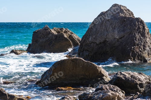 Preview: Turquoise sea stone beach, breaking waves in bright sunlight