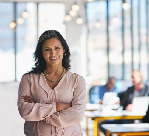 Preview: Portrait of an ambitious young designer posing with her team in the background in the office