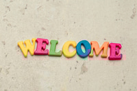 Preview: Word Welcome written in colorful plastic letters close up shot