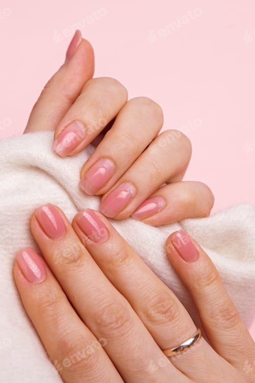 Preview: Nude gel polish. one hand with overgrown nails, groomed, the other with a fresh manicure