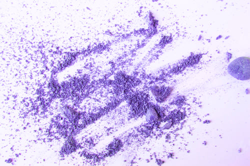 Preview: Lilac or purple eyeshadow, scattered crumbs isolated on white background, beauty and makeup concept
