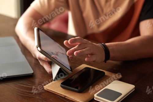 Preview: Trader Analyzing Statistics on Tablet
