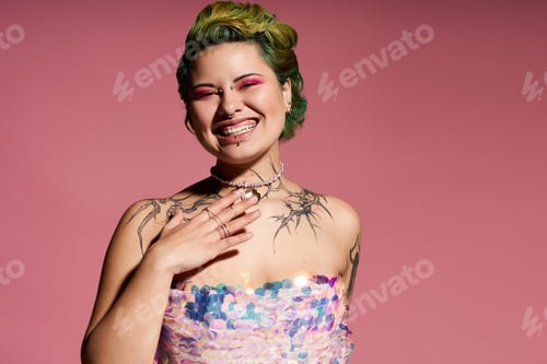 Preview: Vibrant young woman exuding confidence in colorful fashion against a pink backdrop