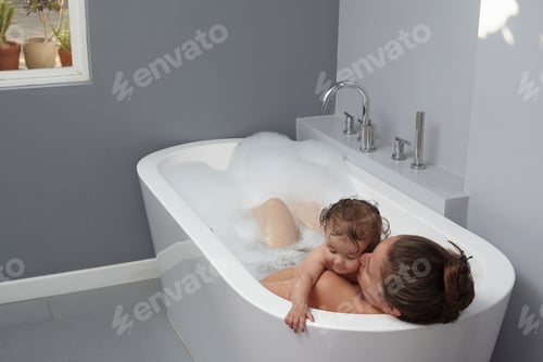 Preview: Mother and baby girl in bathtub