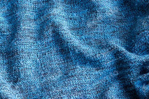 Preview: Bright blue knitted fabric texture. Crumpled blanket background