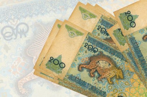 Preview: 200 Uzbekistani som bills lies in stack on background of big semi-transparent banknote. Abstract pr
