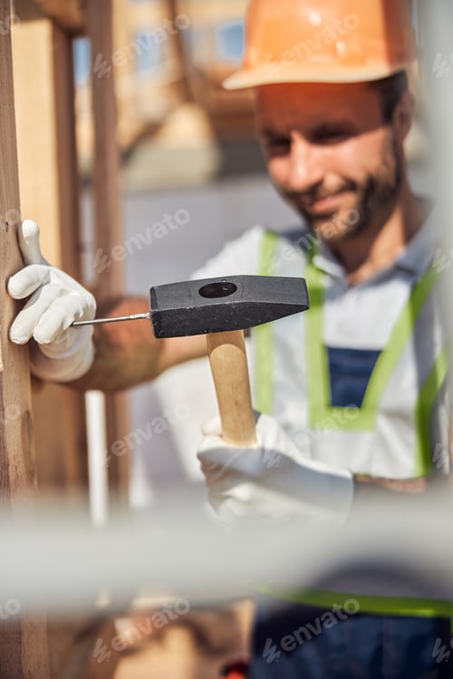Preview: Focused photo on hammer being in male hand