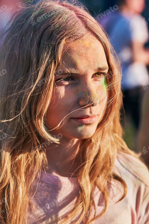 Preview: Portrait of young girl with colorful paints on faces and clothes